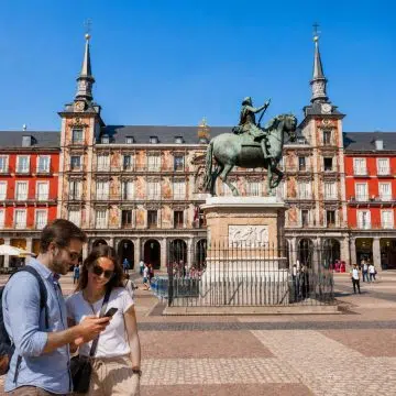 Enclosed by uniform red-brick Habsburg architecture and grand porticoes, Plaza Mayor is Madrid's iconic 17th-century central square, centered around a bronze equestrian statue of King Philip III.