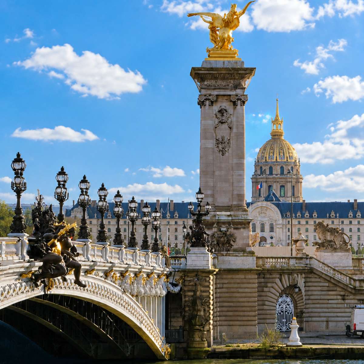 Paris Scavenger Hunt and Self-Guided Tour 5 The Pont Alexandre III is a majestic Beaux-Arts bridge adorned with ornate golden statues and lamp posts that connect the Champs-Élysées to the Invalides across the Seine.
