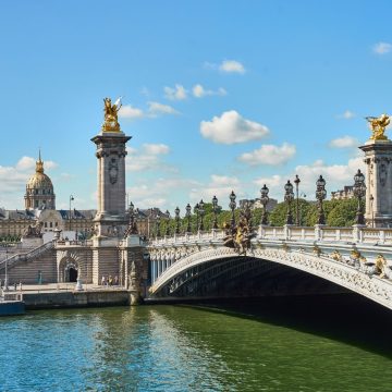 Spanning the Seine to connect the Champs-Élysées quarter with Les Invalides, the Beaux-Arts Pont Alexandre III is celebrated as Paris's most ornate bridge, famed for its extravagant gilded statues, Art Nouveau lamp posts, and low-slung single-span steel arch.