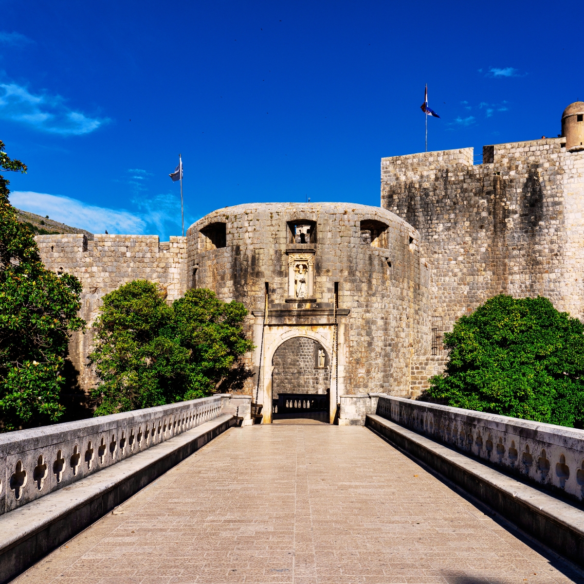 Dubrovnik Scavenger Hunt and Self-Guided Tour 3 The Pile Gate is the grand main entrance to Dubrovnik's Old Town, featuring a stone bridge and a Renaissance archway that have welcomed visitors into the fortified city for centuries.