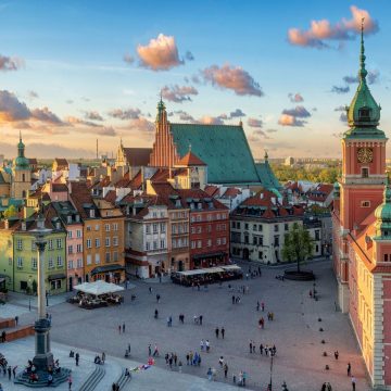 Framed by colorful rebuilt townhouses, Warsaw's Old Town Market Place centers on the iconic bronze Mermaid statue.