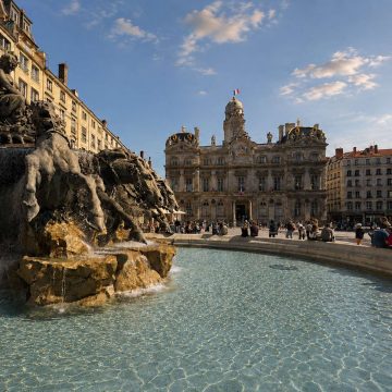 Place des Terreaux is a majestic historic square where a grand monumental fountain and the surrounding classical architecture create a vibrant cultural centerpiece in the heart of Lyon.