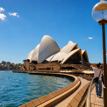 Jutting gracefully into the harbour on Bennelong Point, the Sydney Opera House stands as a modernist masterpiece celebrated for its interlocking white precast concrete shells that echo billowing sails against the open water.
