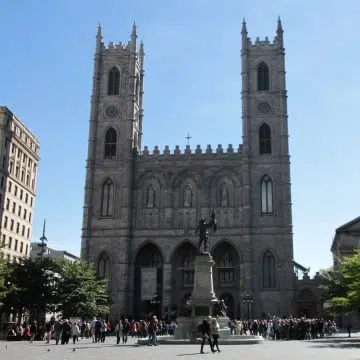 The Notre-Dame Basilica in Montreal is a magnificent Gothic Revival landmark, celebrated for its dramatic twin towers, richly decorated interior, vivid stained glass, and striking blue-and-gold sanctuary.