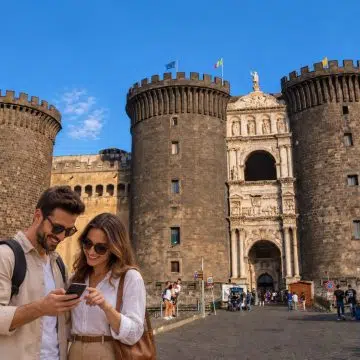 Built in the 13th century, Naples' medieval fortress Castel Nuovo features imposing cylindrical stone towers and an ornate Renaissance triumphal arch.