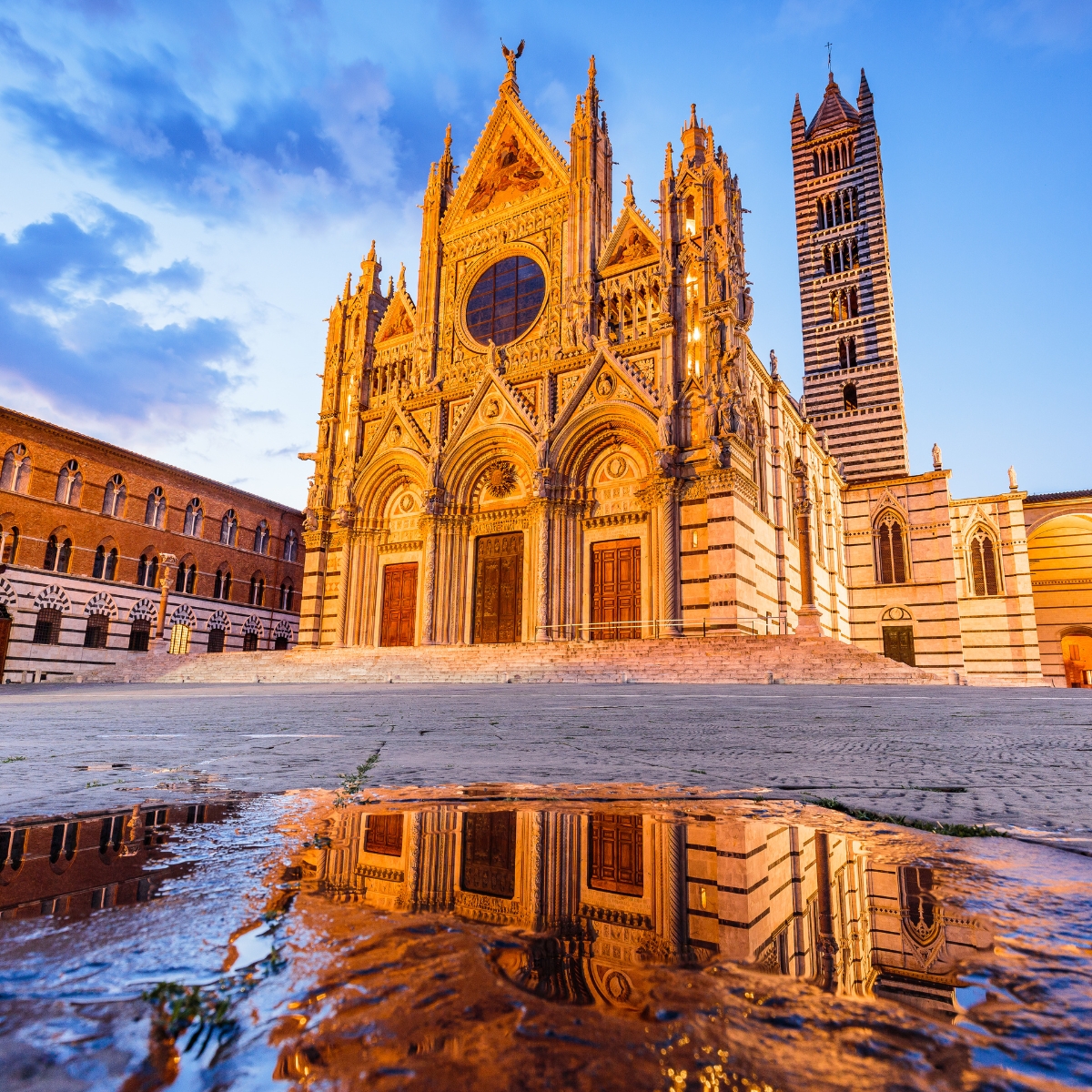 Siena Scavenger Hunt and Self-Guided Tour 5 Siena Cathedral is a majestic Gothic landmark where a grand black-and-white striped facade and intricate marble floor mosaics create a monumental masterpiece in the heart of Tuscany.