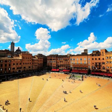 Piazza del Campo is a majestic shell-shaped square where a grand red-brick pavement and the soaring Torre del Mangia create a monumental heart for Siena’s historic traditions.