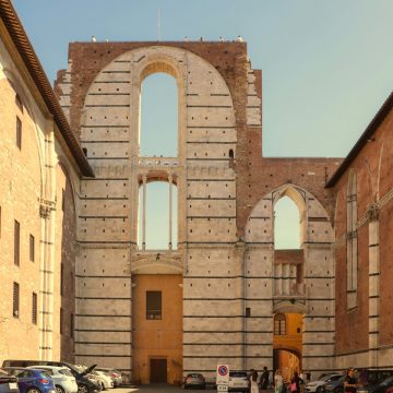Facciatone is a majestic architectural landmark where a grand unfinished facade and a panoramic lookout point create a monumental vantage point over the historic skyline of Siena.
