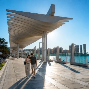 The Palmeral de Las Sorpresas is a scenic waterfront promenade in Málaga lined with palm trees, sculptural pergolas, and relaxing fountains.