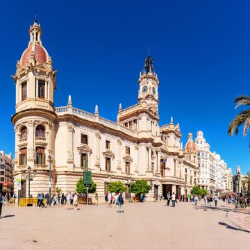 Valencia City Hall is a majestic architectural landmark where a grand neoclassical facade and the historic clock tower overlook the vibrant pulse of the city's central square.