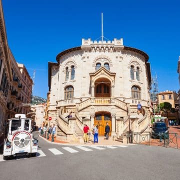 Constructed in 1924 using porous sea tuff, the Palace of Justice in Monaco stands beside the cathedral with an elegant curved facade and sweeping twin staircases that house the principality's legal courts.