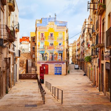 Plaça dels Sedassos is home to one of Tarragona's most famous murals, a vibrant trompe-l'oeil that brings a traditional 19th-century facade to life with colorful local characters. This charming square seamlessly blends street art with history, offering a playful glimpse into the city's Mediterranean soul and architectural heritage.