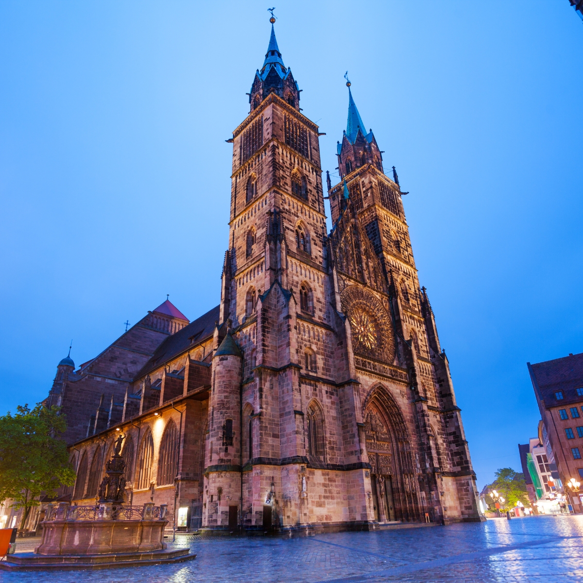 Nuremberg Scavenger Hunt and Self-Guided Tour 6 St. Lawrence Church is a masterpiece of German Gothic architecture, featuring soaring twin towers and a magnificent rose window that illuminates its treasury of medieval art and stone carvings.