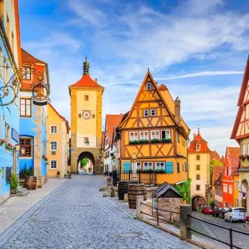 Framed by a crooked half-timbered house and two fairytale medieval gate towers, this iconic cobblestone fork is the most photographed and picturesque corner of Rothenburg ob der Tauber.