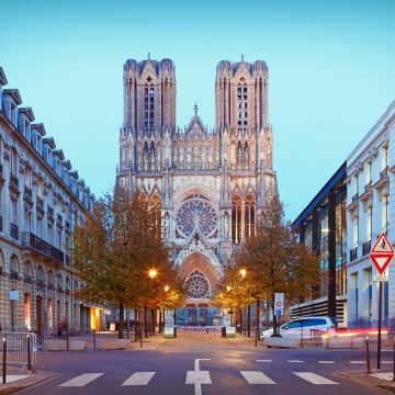 The Notre-Dame de Reims is a French Gothic masterpiece famous as the site where France's kings were traditionally crowned and is renowned for its facade adorned with over 2,300 statues, including the "Smiling Angel."