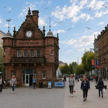 St Enoch Square in Glasgow is a lively city-centre space where historic character meets modern Glasgow, surrounded by shops, striking architecture, and the distinctive former subway station building.