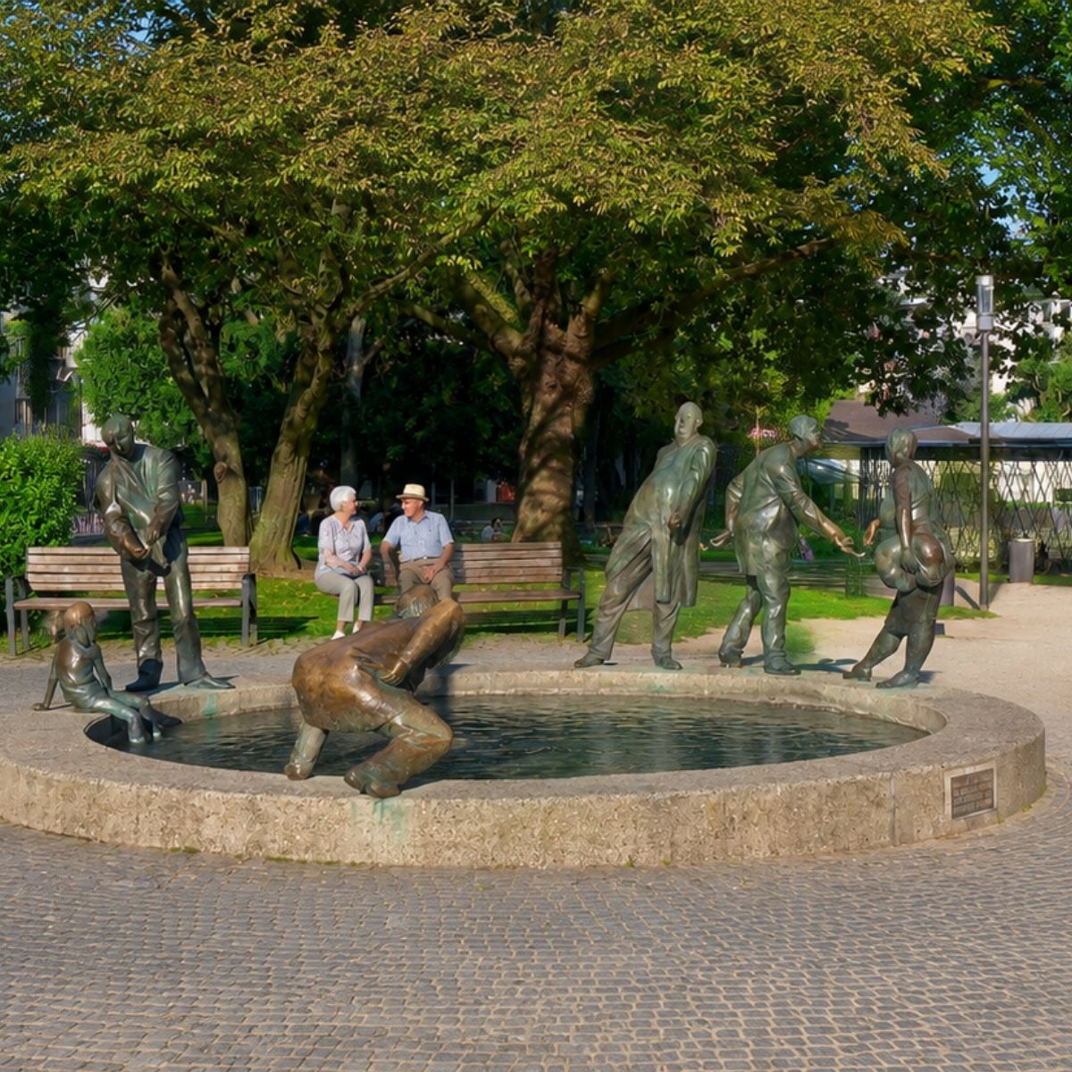 Aachen Scavenger Hunt and Self-Guided Tour 5 Known as the "Circulation of Money" fountain, the fascinating "Kreislauf des Geldes" Brunnen features whimsical bronze figures moving around a basin of warm thermal water to symbolize greed, power, and the endless flow of wealth.