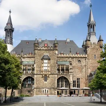 The Aachen Town Hall is a majestic Gothic building constructed on the foundations of Charlemagne’s palace, standing as a grand symbol of civic history that overlooks the historic Katschhof square.
