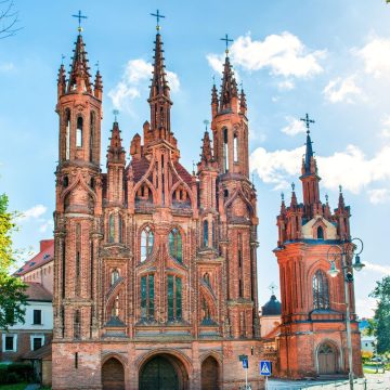 Perched beside the Vilnia River, this late-fifteenth-century landmark stands out for its intricate, flame-like brick facade that survived centuries of warfare virtually untouched.