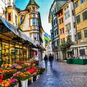 Piazza delle Erbe is a vibrant, historic square in Bolzano that has served as a bustling marketplace for fruit, vegetables, and local delicacies since the 13th century. It is famously home to the Neptune Fountain, an 18th-century bronze landmark that stands amidst the surrounding colorful facades and traditional Alpine-style buildings.