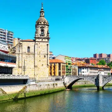 San Anton Church is a majestic Gothic landmark where a grand stone facade and its historic location beside the river create a monumental presence in Bilbao’s Old Town.