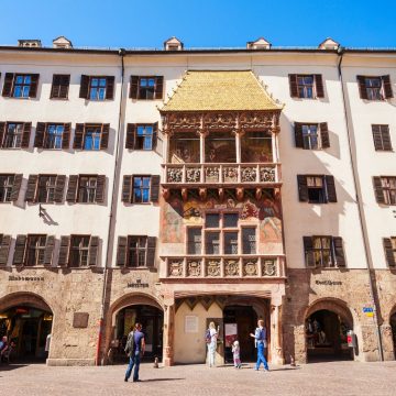 Completed in 1500 for Emperor Maximilian I, Innsbruck's iconic Golden Roof (Goldenes Dachl) is an ornate late-Gothic oriel balcony adorned with 2,657 fire-gilded copper tiles, intricate reliefs, and painted frescoes overlooking the Old Town square.