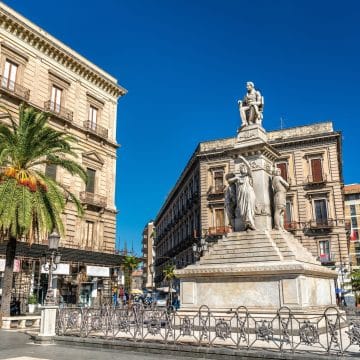 Centering Catania's urban pulse along Via Etnea, Piazza Stesicoro showcases sunken Roman amphitheater ruins set against grand neoclassical palaces and a soaring marble monument to native composer Vincenzo Bellini.