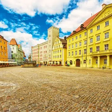 Haidplatz to historyczny, trójkątny plac w samym sercu Ratyzbony, otoczony wspaniałymi średniowiecznymi domami patrycjuszy i przypominającym fortecę Złotym Krzyżem.