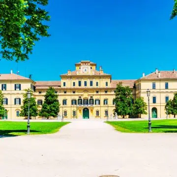 The Palazzo del Giardino is a stunning 16th-century ducal residence characterized by its elegant Mannerist architecture and ornate frescoes, nestled within the lush, manicured greenery of Parma's Parco Ducale.